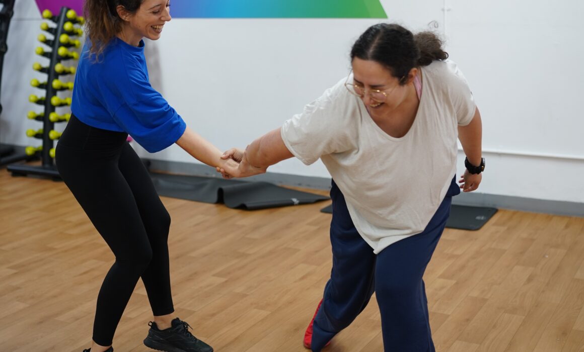 Two women take part in a self defence class